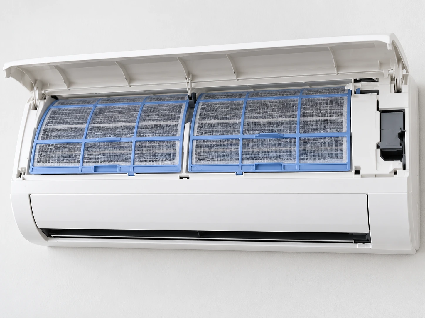 Wall-mounted air conditioner with its front cover open and filters visible